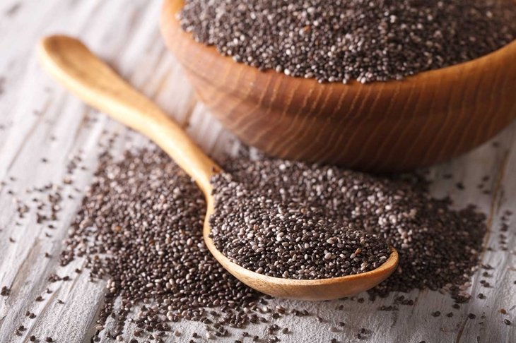 Healthy Chia seeds in a wooden spoon on the table close-up. horizontal