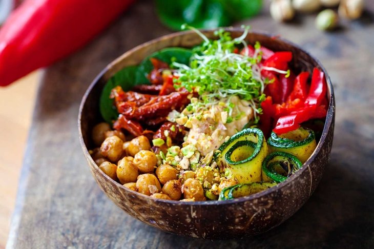 Vegan Buddha bowl with chickpeas, courgette, sundried tomatoes and sprouts